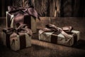 Gift boxes with brown bows on vintage woode background