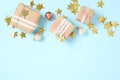 Gift boxes, Christmas balls and golden confetti on light blue background, flat lay. Space for text Royalty Free Stock Photo