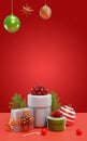 Gift boxes, Christmas tree branches and hanging decorations on a red background. 3D rendering Royalty Free Stock Photo