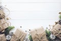 Gift boxes collection wrapped in kraft paper with border pine on white wood background Royalty Free Stock Photo