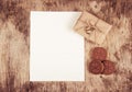 Gift boxes and cookies hearts on a wooden background. An empty sheet of paper and a gift. Royalty Free Stock Photo