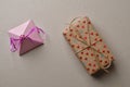 Gift boxes in crafting for Valentine`s Day on a cardboard beige background with space for your creativity