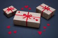 Gift boxes decorated with red ribbons with bows lie on a black background Royalty Free Stock Photo