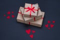 Gift boxes decorated with red ribbons with bows lie on a black background Royalty Free Stock Photo