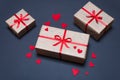 Gift boxes decorated with red ribbons with bows lie on a black background Royalty Free Stock Photo