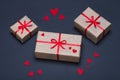 Gift boxes decorated with red ribbons with bows lie on a black background Royalty Free Stock Photo