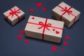 Gift boxes decorated with red ribbons with bows lie on a black background Royalty Free Stock Photo