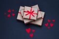 Gift boxes decorated with red ribbons with bows lie on a black background Royalty Free Stock Photo