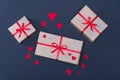 Gift boxes decorated with red ribbons with bows lie on a black background Royalty Free Stock Photo