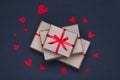 Gift boxes decorated with red ribbons with bows lie on a black background Royalty Free Stock Photo