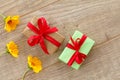 Gift boxes with flowers on the wooden background Royalty Free Stock Photo