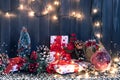 Gift boxes and garland lights over old wooden background. Christmas and new year concept Royalty Free Stock Photo