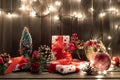 Gift boxes and garland lights over old wooden background. Christmas and new year concept Royalty Free Stock Photo