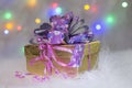 Gift boxes with a large red bow against a background bokeh of twinkling party lights. Royalty Free Stock Photo