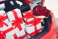 Gift boxes in a luggage carrier of the red car Royalty Free Stock Photo