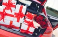 Gift boxes in a luggage carrier of the red car Royalty Free Stock Photo