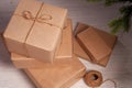 Gift boxs wrapped in recycled paper with bow. Merry Christmas and Happy Holidays! Christmas gift box against bokeh background. Royalty Free Stock Photo