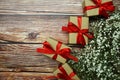 Gift boxes with red ribbon and flower decoration on wooden background Royalty Free Stock Photo