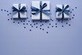 Gift boxes with ribbon and bow on blue background with confetti stars . Top view and space for text Royalty Free Stock Photo