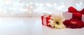 Gift boxes with ribbons and flowers on a white delicate background with bokeh