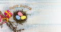 Gift boxes with ribbons. Happy Easter. Willow twigs. Holy Easter. Blue turquoise background. Easter eggs in the nest Royalty Free Stock Photo