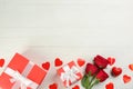 Gift boxes, roses and hearts on white wooden background, flat lay with space for text. Valentine`s Day celebration Royalty Free Stock Photo