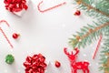 Gift boxes scarlet. White gifts with red ribbon, New Year balls and sparkling lights in Christmas composition on white background Royalty Free Stock Photo