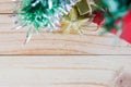 Gift boxes and stars unter chirstmas tree on the wooden board