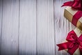 Gift boxes with tied red bows on wood board copy space holidays Royalty Free Stock Photo