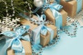 Gift boxes wrapped in craft paper with blue satin ribbons