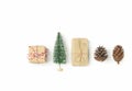 Gift boxes wrapped in craft paper Christmas tree pine cones arranged in row on solid white background. Knolling flat lay. New Year Royalty Free Stock Photo