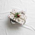 Gift boxes wrapped in white paper adorned with Christmas-themed Royalty Free Stock Photo
