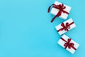 Gift boxes wrapped white paper and red ribbon on blue background. Top view. Flat lay.  Christmas and New Year holidays concept Royalty Free Stock Photo