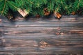 Gift boxwith cinnamon sticks, anise stars, pine cones and pine branches on wooden table. Top view. Christmas gifts in woodan style