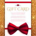 Gift card with red bow on golden glitter background Royalty Free Stock Photo