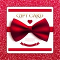 Gift card with red bow on red glitter background Royalty Free Stock Photo