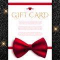 Gift card with red bow on shiny glitter background Royalty Free Stock Photo