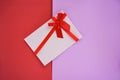 Gift card on red and pink background Gift card decorated with red ribbon bow Royalty Free Stock Photo