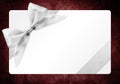 Gift card with silver ribbon bow Isolated on red backgrou Royalty Free Stock Photo