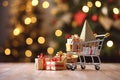 Gift cart standing on a wooden table. Christmas tree background with bokeh.