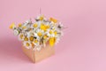 Gift craft box with flowers on pink background Royalty Free Stock Photo