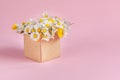 Gift craft box with flowers on pink background Royalty Free Stock Photo