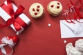 Gift, cupcakes, heart, envelope, angel, ribbons - Valentines day flat lay on red background. Free space for text.