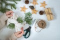 Gift in ecological packaging, fir branches, stars from a vine on a white background. Christmas gift wrapping in traditional Royalty Free Stock Photo