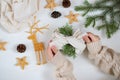 Gift in ecological packaging, fir branches, stars from a vine on a white background. Christmas gift wrapping in traditional Royalty Free Stock Photo