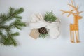 Gift in ecological packaging, fir branches, stars from a vine on a white background. Christmas gift wrapping in traditional Royalty Free Stock Photo