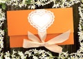 gift envelope tied with a pink ribbon on dark wooden background with flowers of cherry Royalty Free Stock Photo