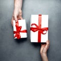 Gift exchange concept. Man changes gifts with a woman, top view. Birthday, Valentines Day, Anniversary, Holiday Concept Royalty Free Stock Photo