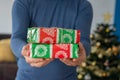 gift giving man hand holding a gift box in a gesture of giving Christmas concept Royalty Free Stock Photo