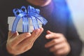 gift giving,man hand holding a gift box in a gesture of giving.blured background Royalty Free Stock Photo